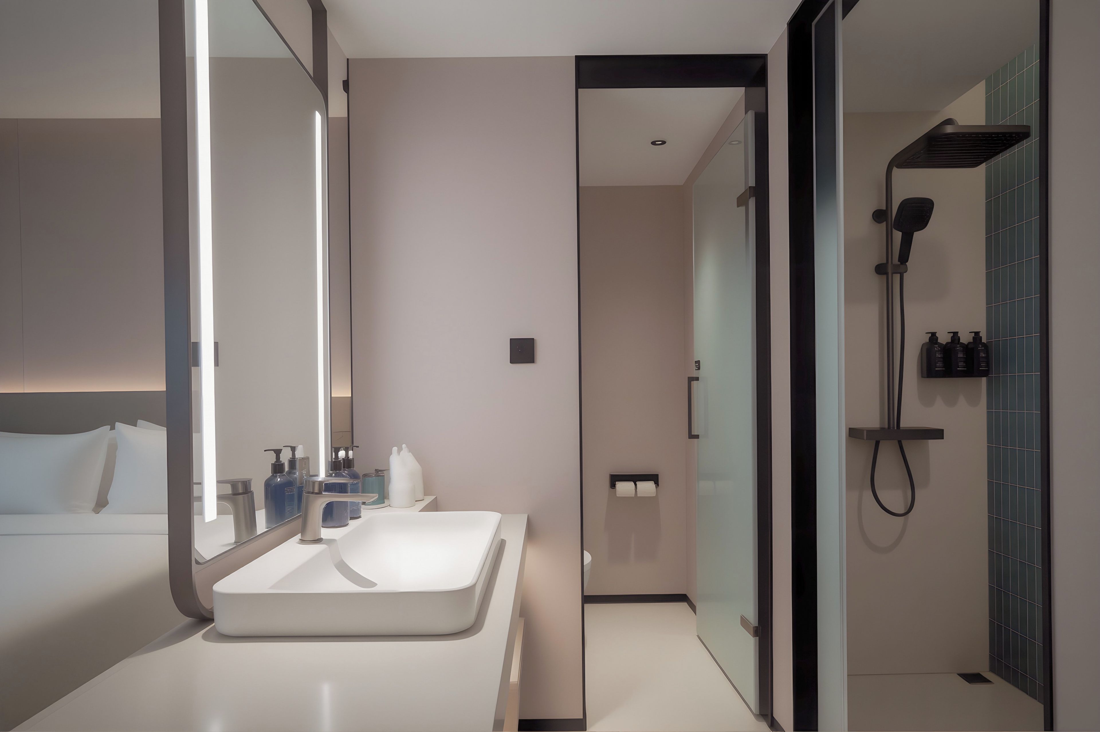 A modern bathroom with a large mirror, a white sink, and a shower area.