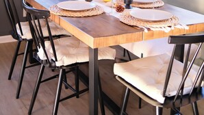 A dining table set with placemats, wine glasses, and a centerpiece of flowers. - ColdPlunge/ HotTub/ Firepit/ BBQ/ Pet Friendly/ SunsetViews near Yosemite (Coarsegold)