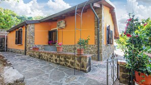 A stone-walled building with an orange facade, a small porch with potted plants, and a metal railing. - Gorgeous home in Perdifumo with WiFi (Perdifumo)
