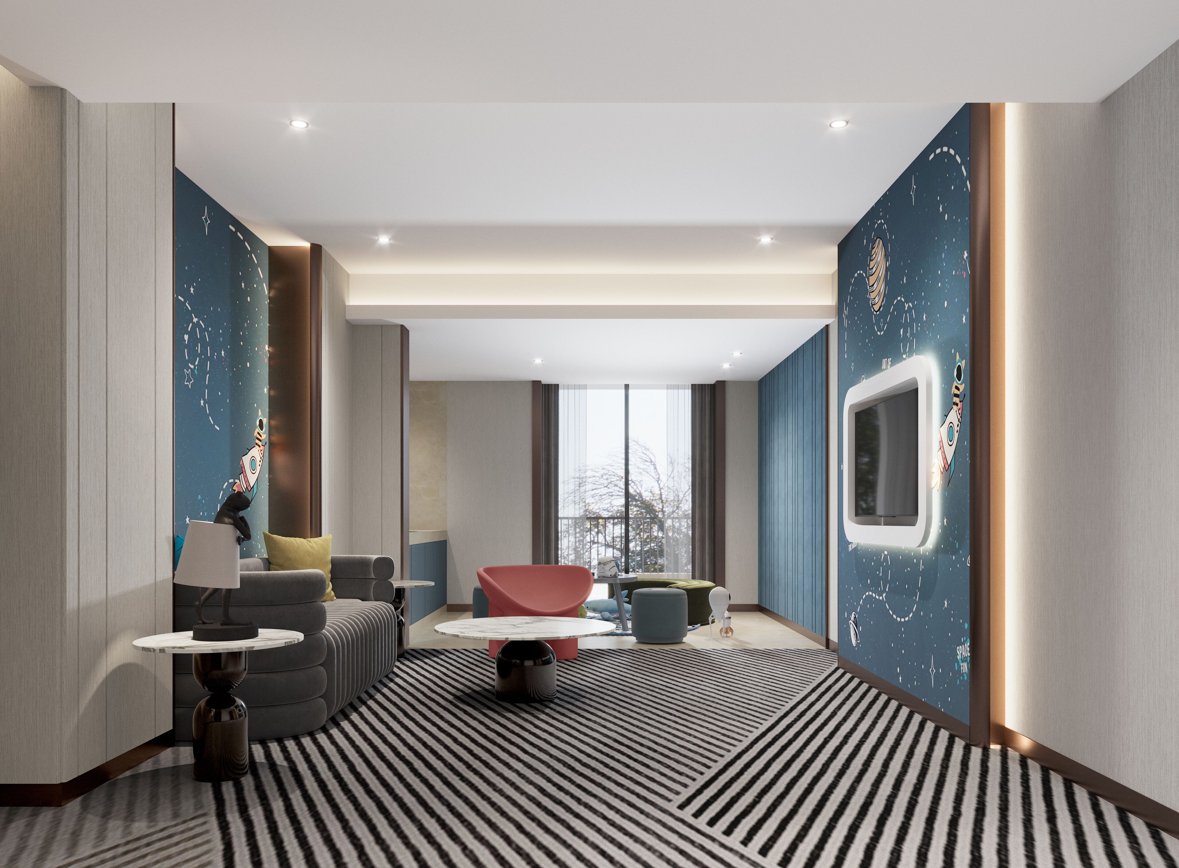 A modern hotel room with a large window, a sofa, a red chair, and a patterned rug.