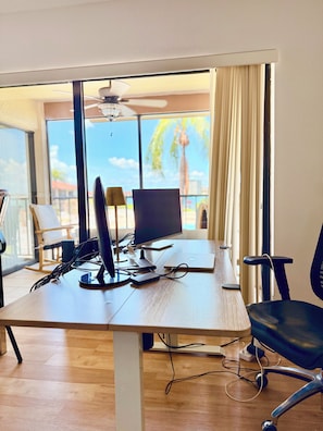 A modern office space with a desk, computer, and chair.