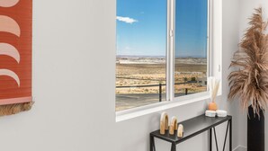 A room with a large window offering a view of a desert landscape. - Lakeview Oasis at Powell - Heated Pool+Lake Views+Game Room (Page)
