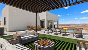 A modern outdoor patio with a fire pit, seating area, and a pool. - Lakeview Oasis at Powell - Heated Pool+Lake Views+Game Room (Page)