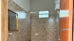 A small bathroom with a sink, toilet, and a mirror.