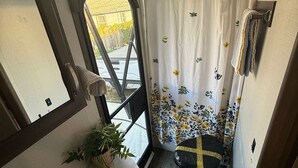 A compact bathroom with a sink, mirror, and shower curtain. - Cozy Glamping RV Private Bathroom Access (Richland)