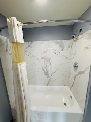 Bathtub, soap, shampoo, toilet paper