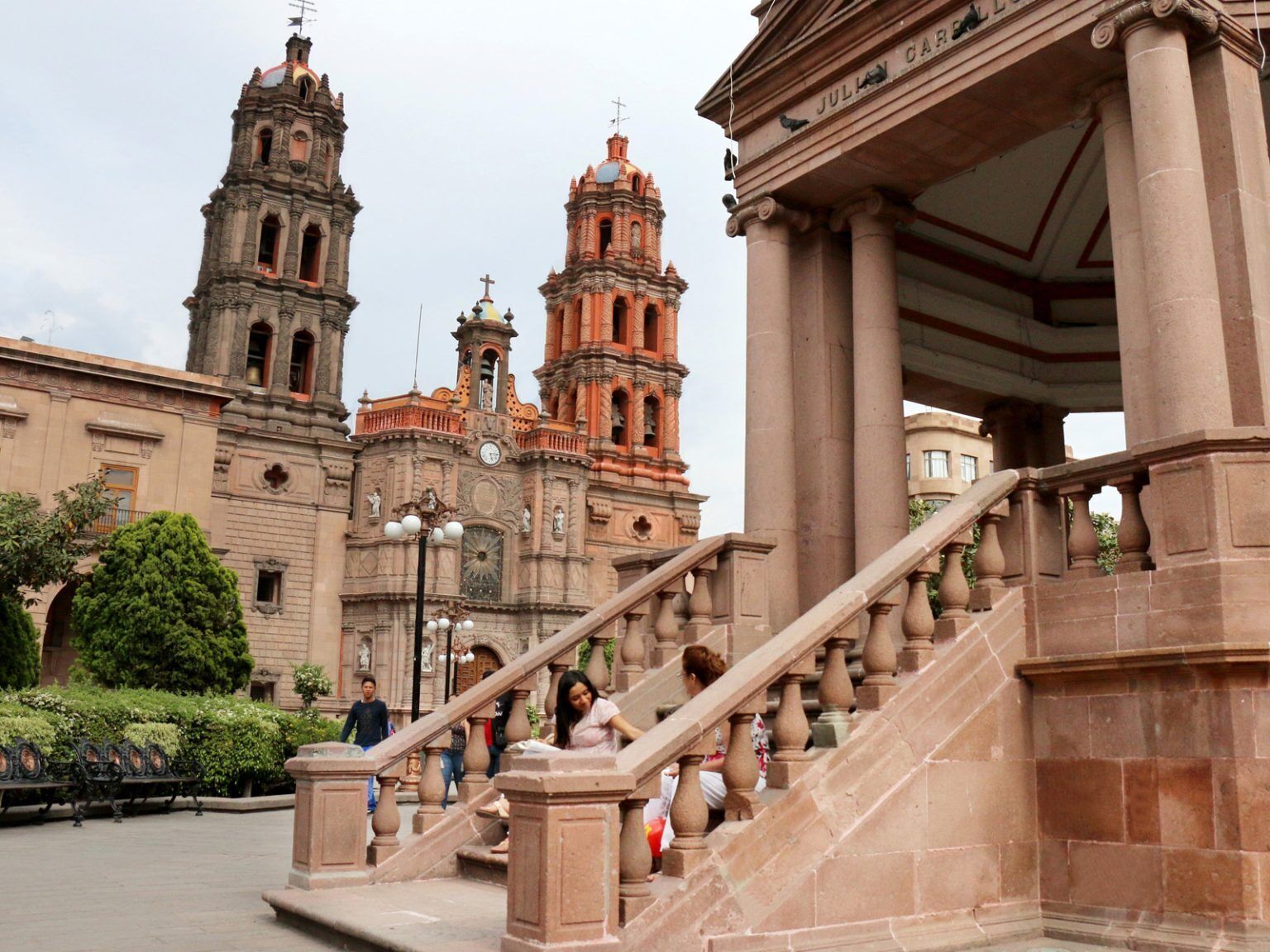 A grand building with two prominent towers and a staircase leading to an entrance.