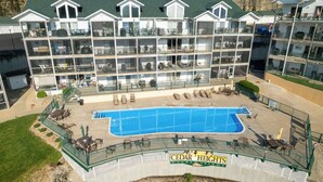 A multi-story building with a swimming pool, outdoor seating, and a sign reading "CEDAR HEIGHTS Condominiums". - Boat Slip, 3 Pools, Golf, Ozarks Amphitheater, & Amazing Lake Views at the 13mm Big Niangua (Camdenton)