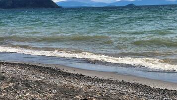 A beach with pebbles and waves.