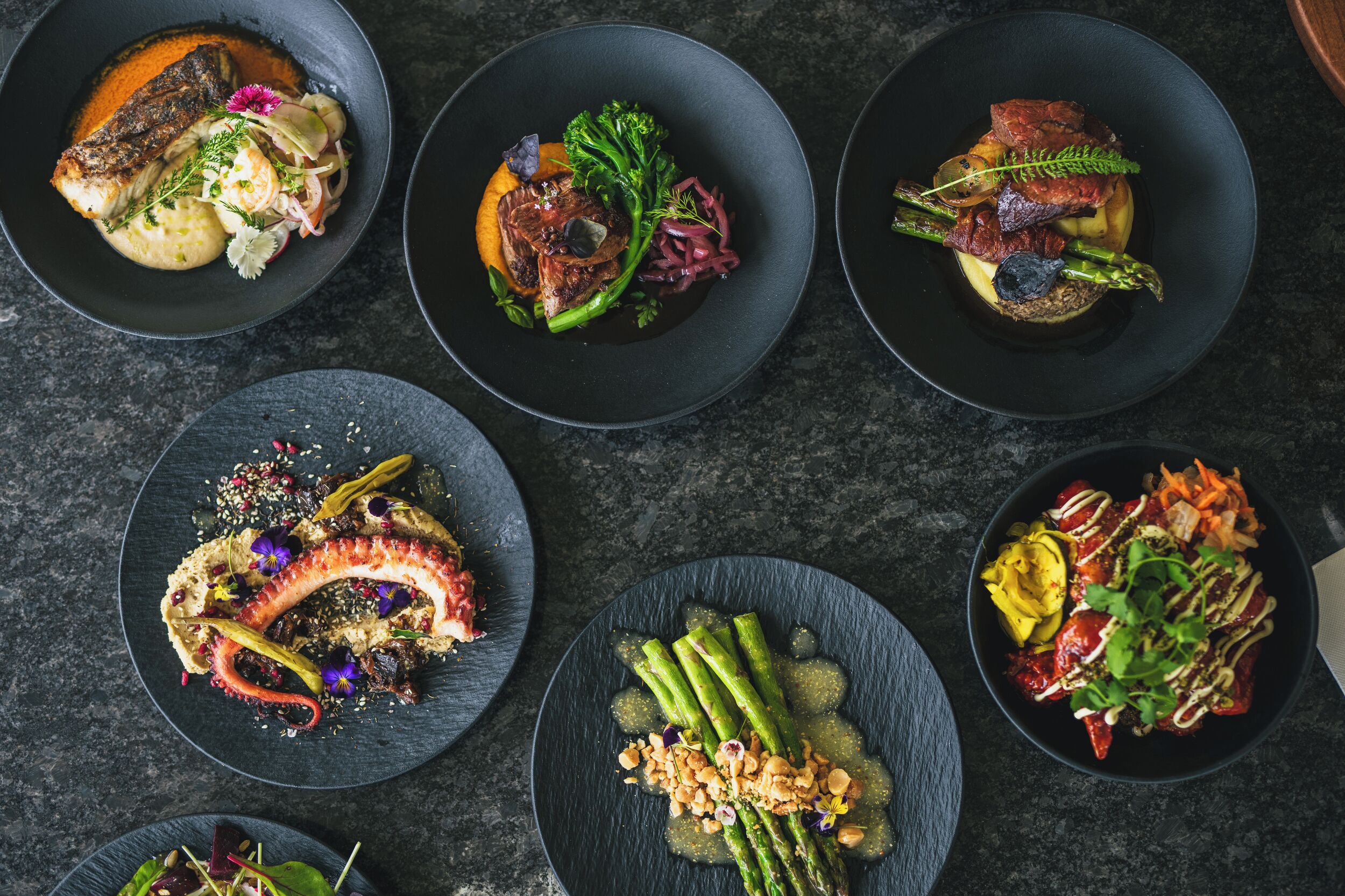 A top-down view of various dishes on plates.