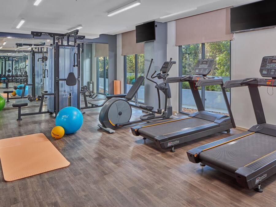 A gym with treadmills, exercise balls, and weight machines.