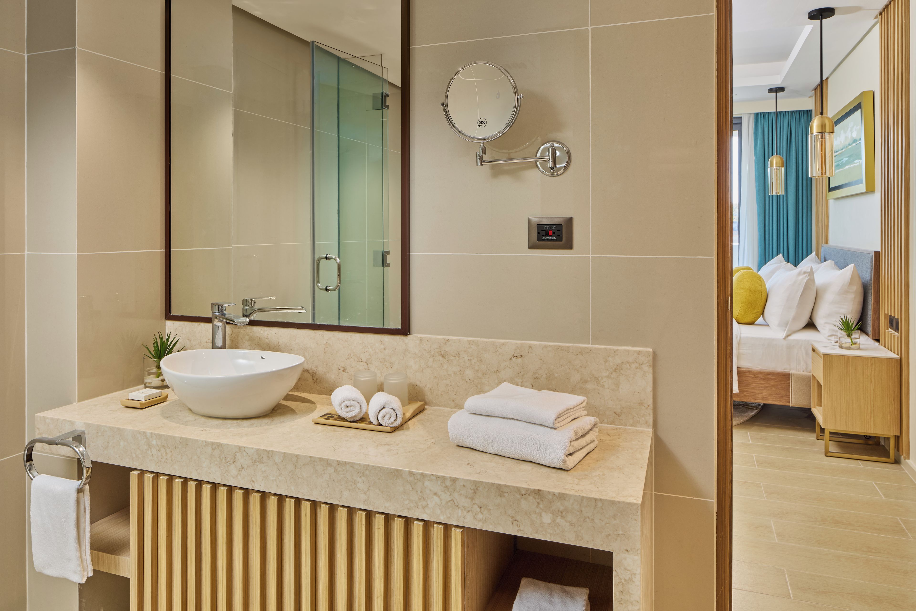 A modern bathroom with a large mirror, a sink, and a towel rack.