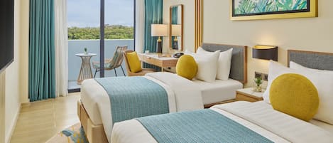 A hotel room with two beds, a desk, a chair, a TV, and a balcony with curtains.