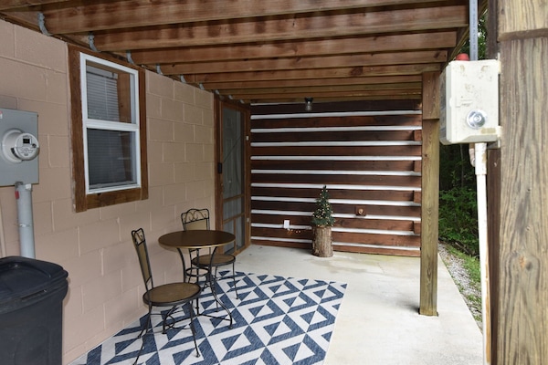 enjoy your morning coffee on the cozy porch with forest views
