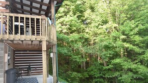 A wooden deck with a view of a forest.