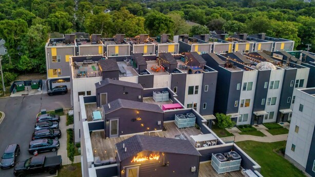 A modern apartment complex with multiple buildings, rooftop terraces, and a parking area. - Music-themed Nashville home sleeps 12 with ping pong game room, pet friendly (Nashville)