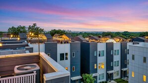 A modern apartment complex with multiple buildings, each featuring balconies and large windows. - Music-themed Nashville home sleeps 12 with ping pong game room, pet friendly (Nashville)