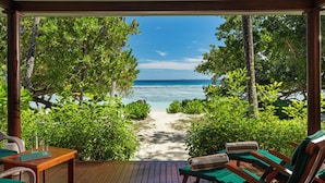 A wooden deck with a view of a beach and ocean. - Niva Labriz Seychelles (Silhouette Island)