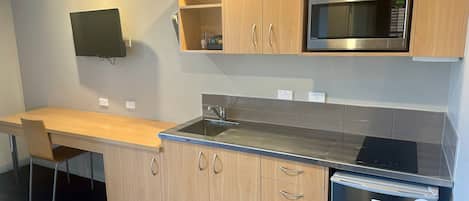Mini-fridge, microwave, stovetop, cookware/dishes/utensils