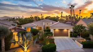 A residential area with houses featuring tiled roofs and well-maintained gardens. - Indio Estate | Pool, Putting Green, Sleeps 12 (Indio)