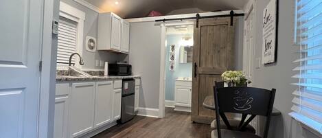 Fridge, microwave, coffee/tea maker, cookware/dishes/utensils
