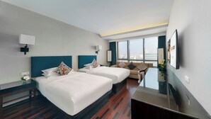 A hotel room with two beds, a sofa, a TV, and a large window offering a city view. - SSAW Boutique Hotel Hefei (Hefei)