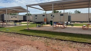 A campground with RV-style cabins, picnic tables, and covered picnic areas. - Discovery Parks Worsktay-Tindal Village (Lansdowne)