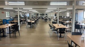 A spacious cafeteria with multiple tables and chairs, high ceilings with fluorescent lighting, and a clean, modern design. - Discovery Parks Worsktay-Tindal Village (Lansdowne)