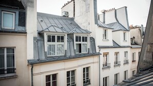 A row of traditional European-style buildings with gabled roofs and multiple windows.