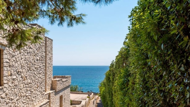A stone building with a view of the sea.