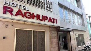 A hotel named "HOTEL RAGHUPATI" with a modern facade, large windows, and a visible entrance. - Hotel Raghupati - Ayodhya (Faizabad)