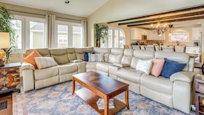 A spacious living room with a sectional sofa, a wooden coffee table, and a kitchen in the background. - Lake Chatuge Home: Boat Dock, Hot Tub & Perks! (Hayesville)