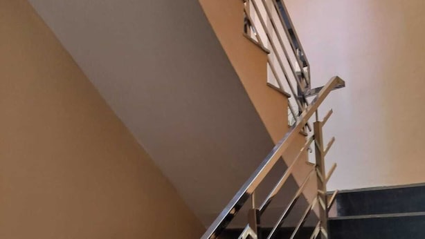 A staircase with metal railings and a handrail, leading to an upper floor. - RIVER SIDE HOTEL PRAYGRAJ (Phulpur)