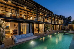 A modern house with a swimming pool, large windows, and outdoor seating areas. - Ahimsa Uluwatu - Ocean View Villa (Pecatu)