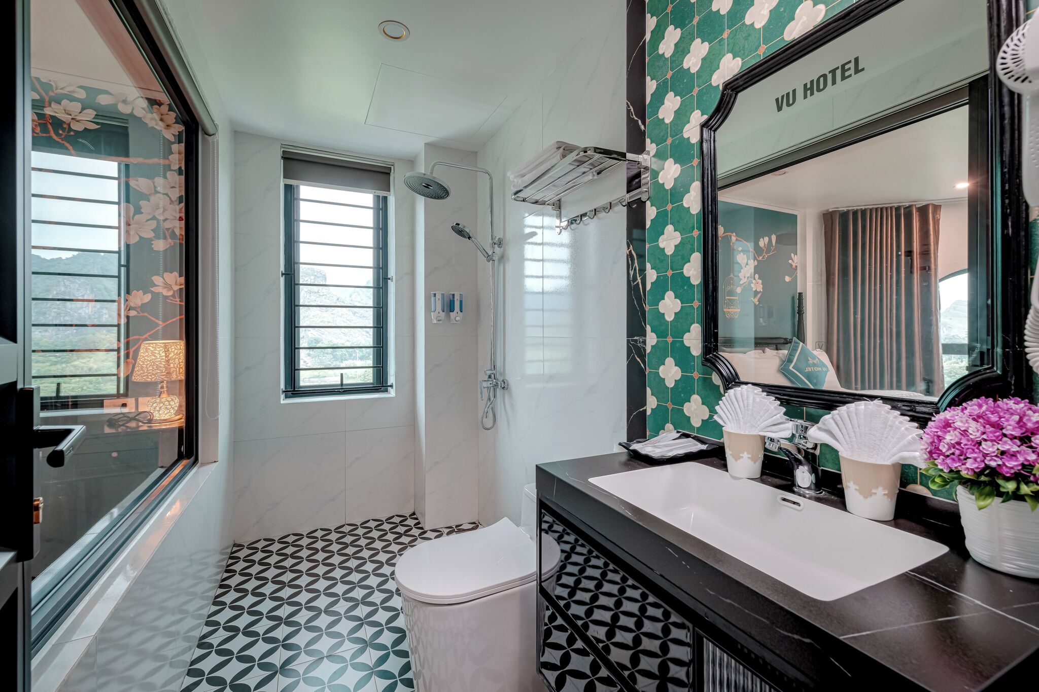 Un baño moderno con un espejo grande, un lavabo y una ducha.