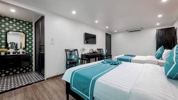 A hotel room with a bed, a desk, a chair, and a TV.