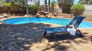 Outdoor pool, open 9:00 AM to 5:00 PM, pool loungers