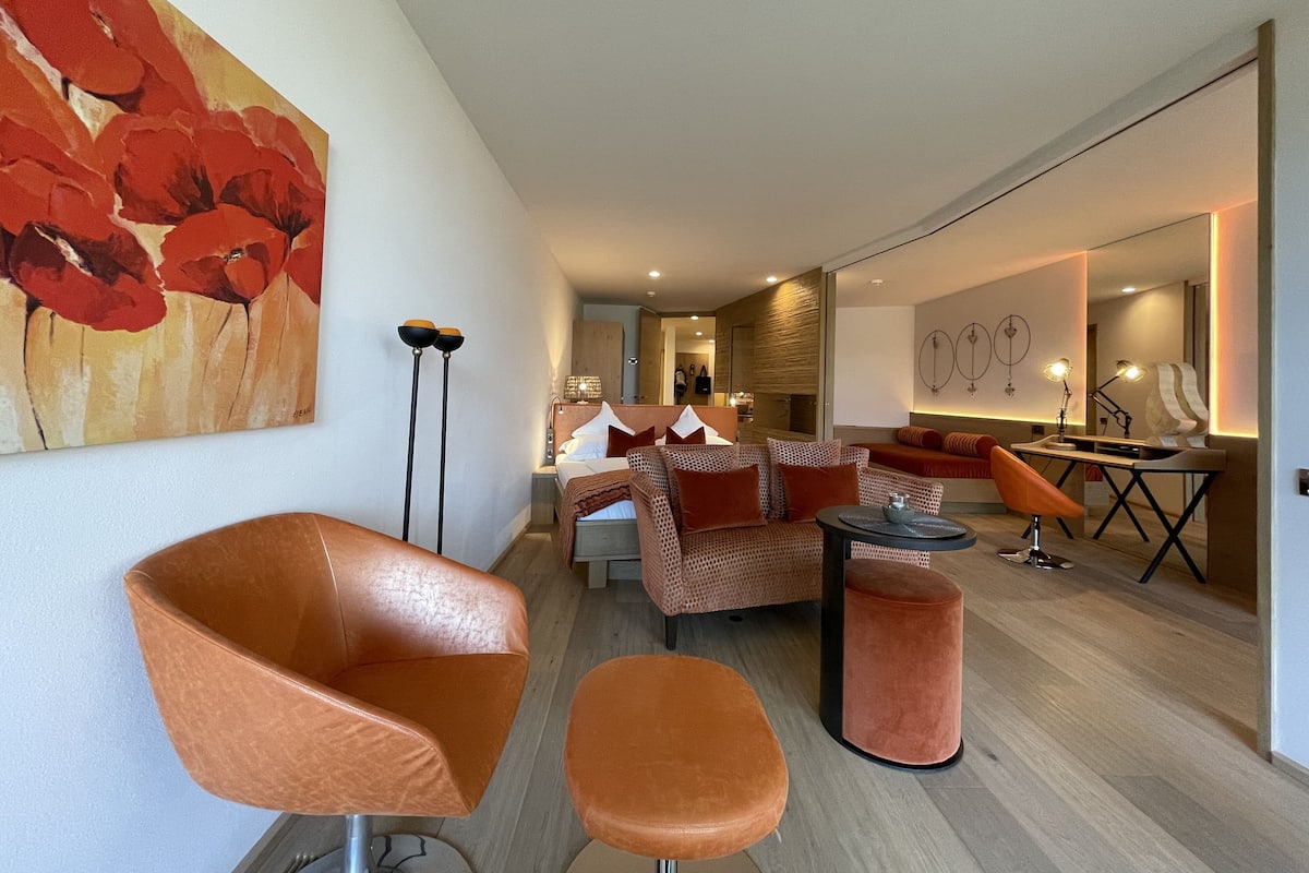 A modern living room with a sofa set, a coffee table, and a floor lamp.