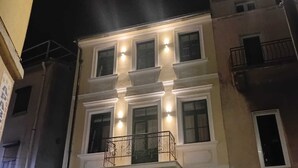 A multi-story building with a balcony on the second floor.