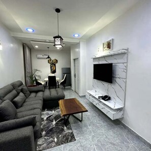 Family Apartment, Balcony, City View | Living area | Flat-screen TV - Bott Apartment (Abuja)