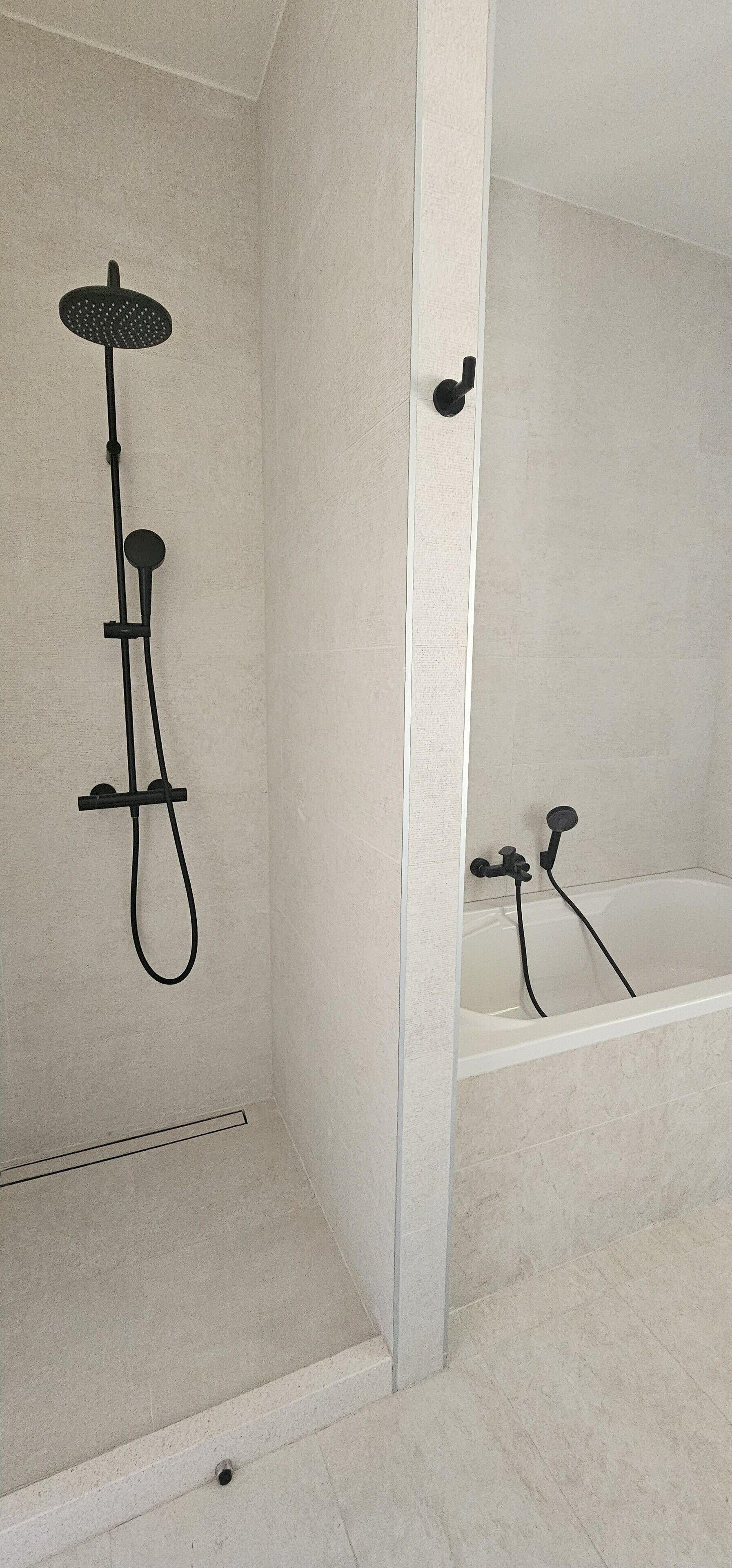 A bathroom with a shower, a bathtub, and a toilet.