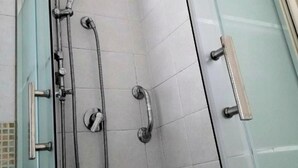 A glass-enclosed shower stall with a handheld showerhead, a wall-mounted faucet, and a handheld showerhead. - Raffaello Beach Apartment Savona, 50 m from the sea, WIFI, AC, equipped kitchen (Savona)