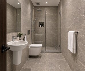 A modern bathroom with a glass-enclosed shower, a white sink, and a toilet. - Viaje Hotel Downtown Cairo (Cairo)
