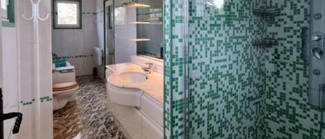 Shower, jetted tub, hair dryer, toilet paper