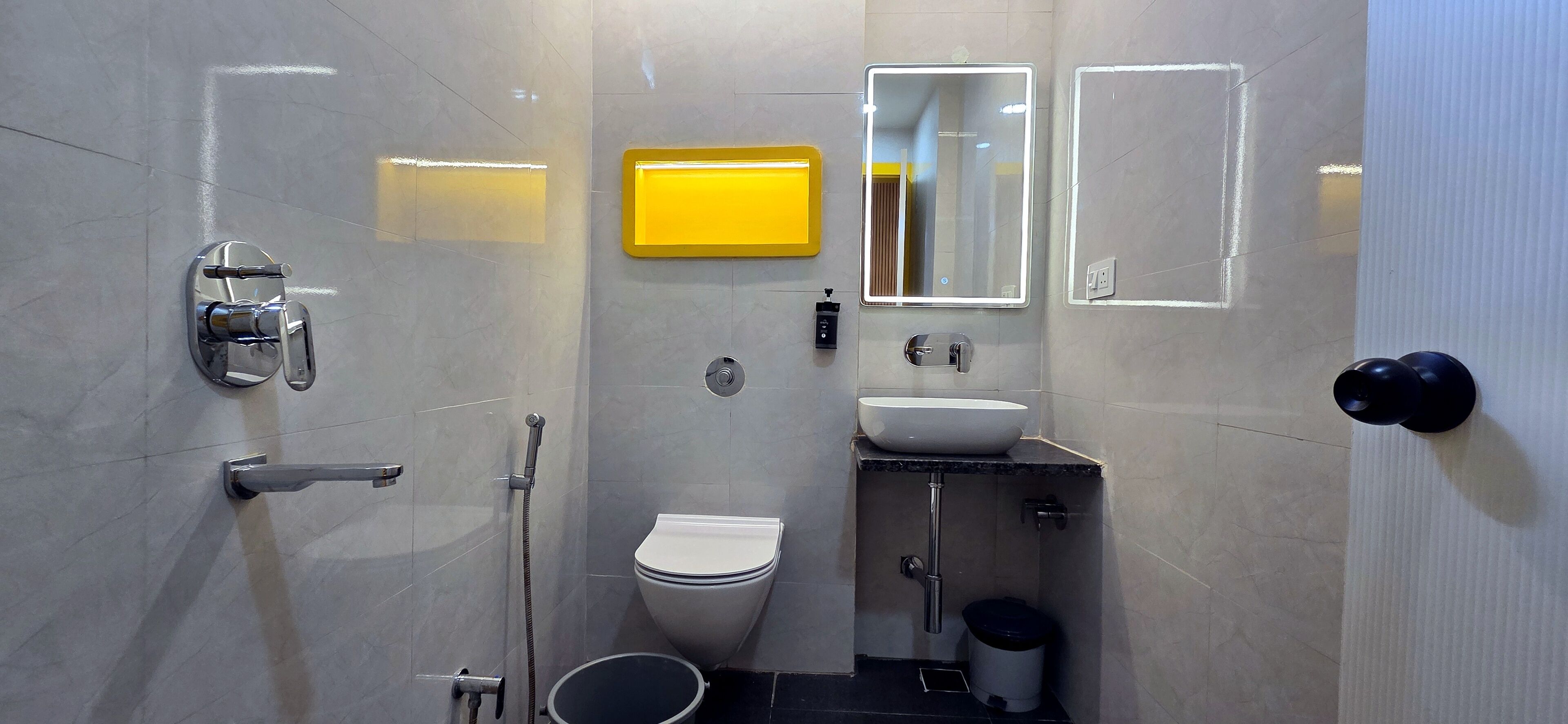 A modern bathroom with a toilet, sink, and shower.