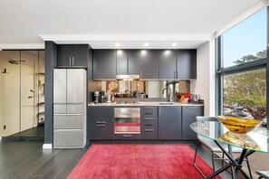 Microwave, stovetop, dishwasher - Cremorne- GA102 Macpherson St - Chic Loft-Style 1BR Apartment with Balcony Rooftop in Heart of Cremorne (Cremorne)