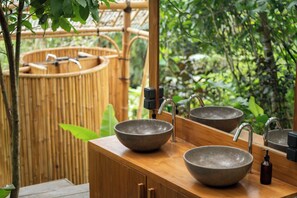 A bathroom with two vessel sinks, a mirror, and a bamboo backdrop. - Nysa Forest Sanctuary (Penebel)