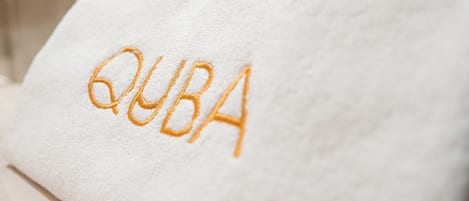 A white towel with the word "CUBA" embroidered in orange.