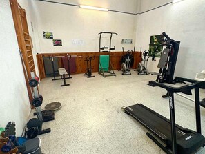 A gym with various exercise equipment including a treadmill, weight bench, and free weights. - Studio for 6 with Wi-Fi, sea view (Roquebrune-Cap-Martin)
