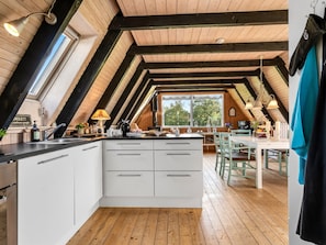 A kitchen with a central island, wooden beams, and a large window. - "Annalia" - 400m from the sea by Interhome (Hadsund)